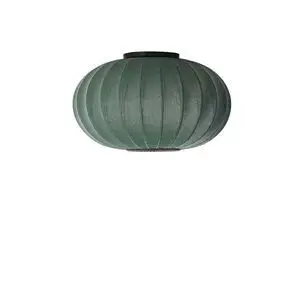 Ovalformet grøn lampe med ribbet tekstur, velegnet til loft eller væg, i tweed-look.